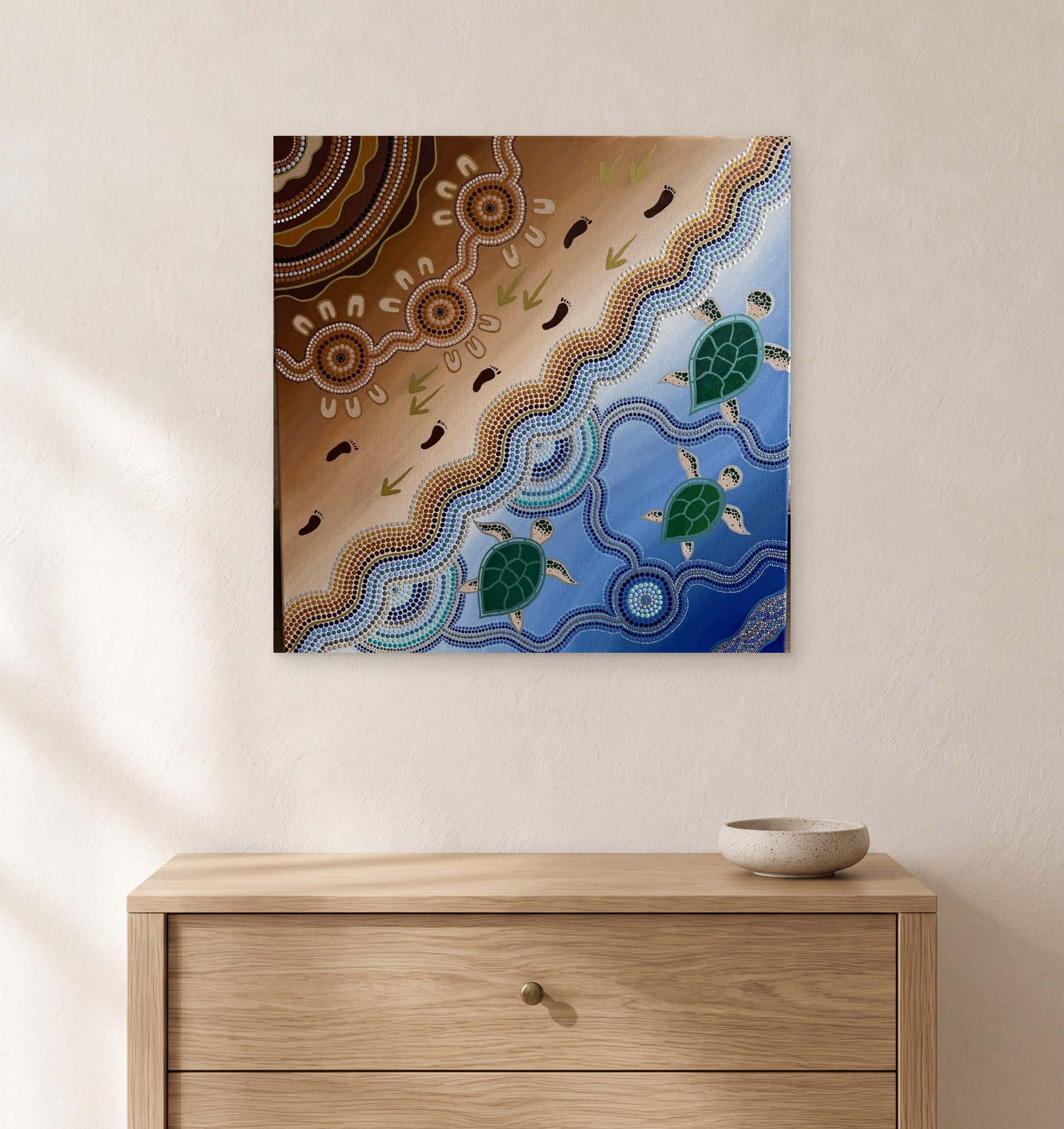 Digital room mockup showing the 51 × 51 cm three-turtle painting above a compact oak chest